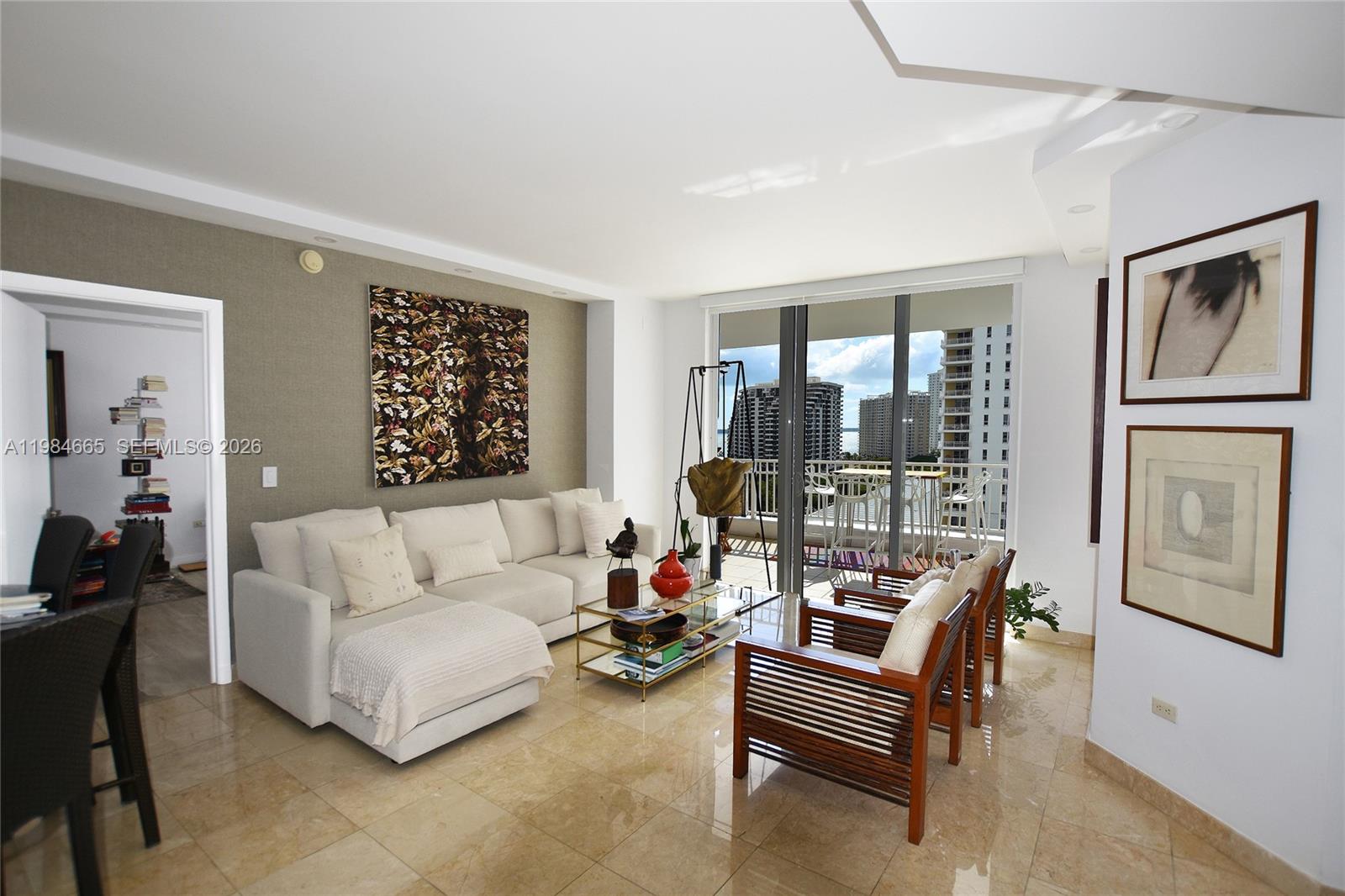 801 Brickell Key Boulevard, Unit 1209 Miami, FL 33131 - Photo 11 of 52 a living room with furniture a ceiling fan and a window