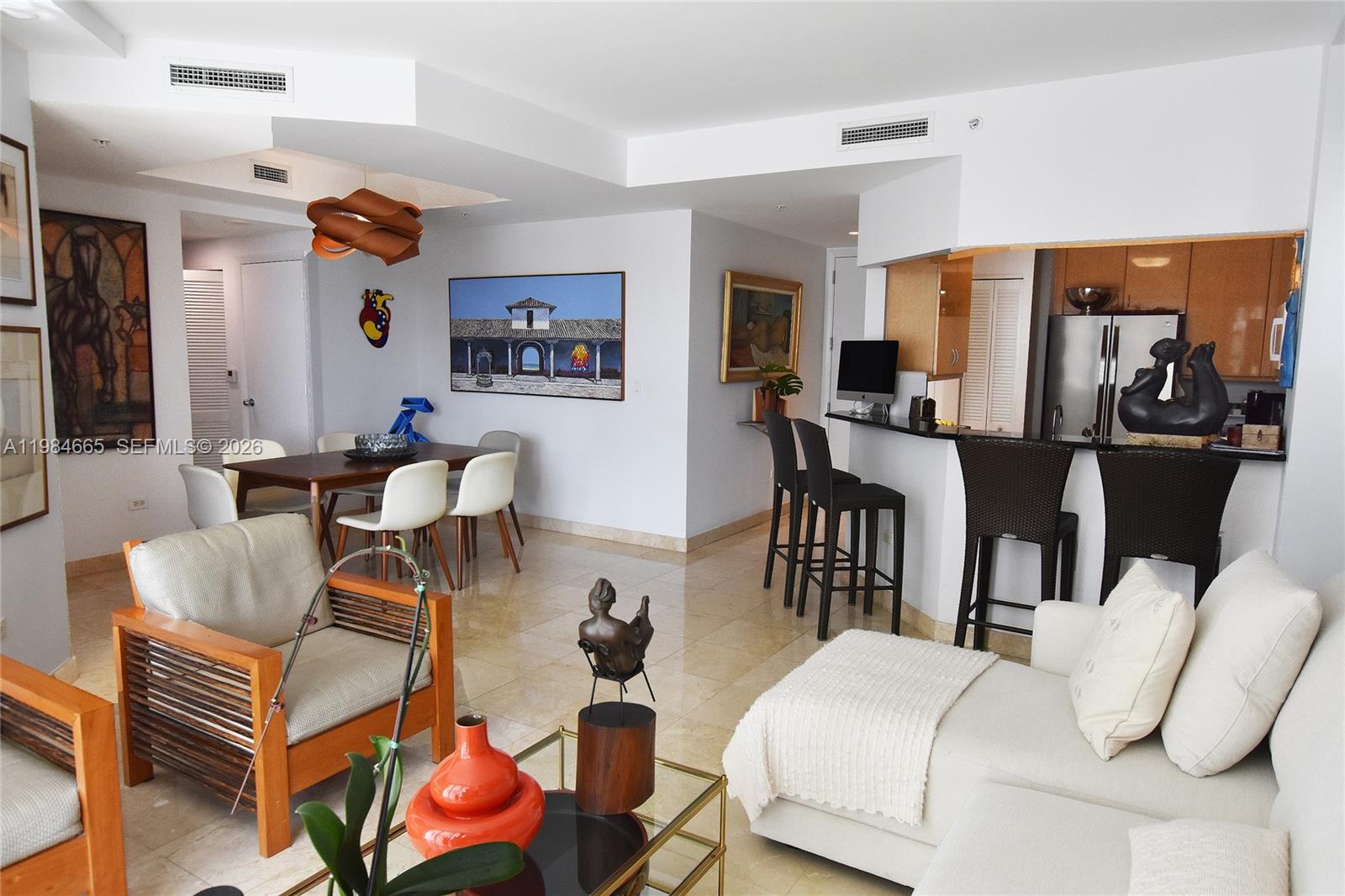 801 Brickell Key Boulevard, Unit 1209 Miami, FL 33131 - Photo 12 of 52 a living room with furniture and wooden floor