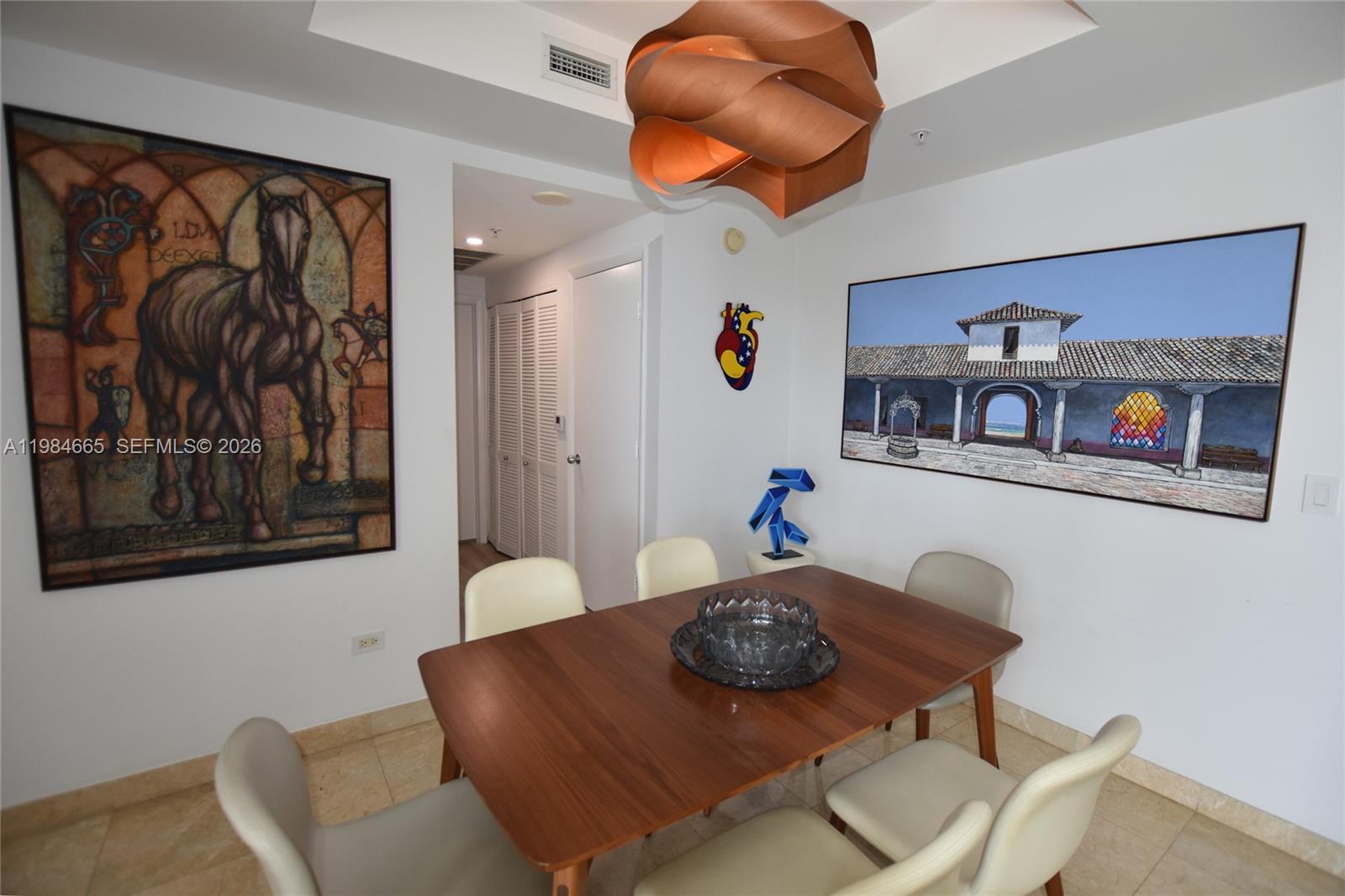 801 Brickell Key Boulevard, Unit 1209 Miami, FL 33131 - Photo 13 of 52 a living room with furniture and wall paintings