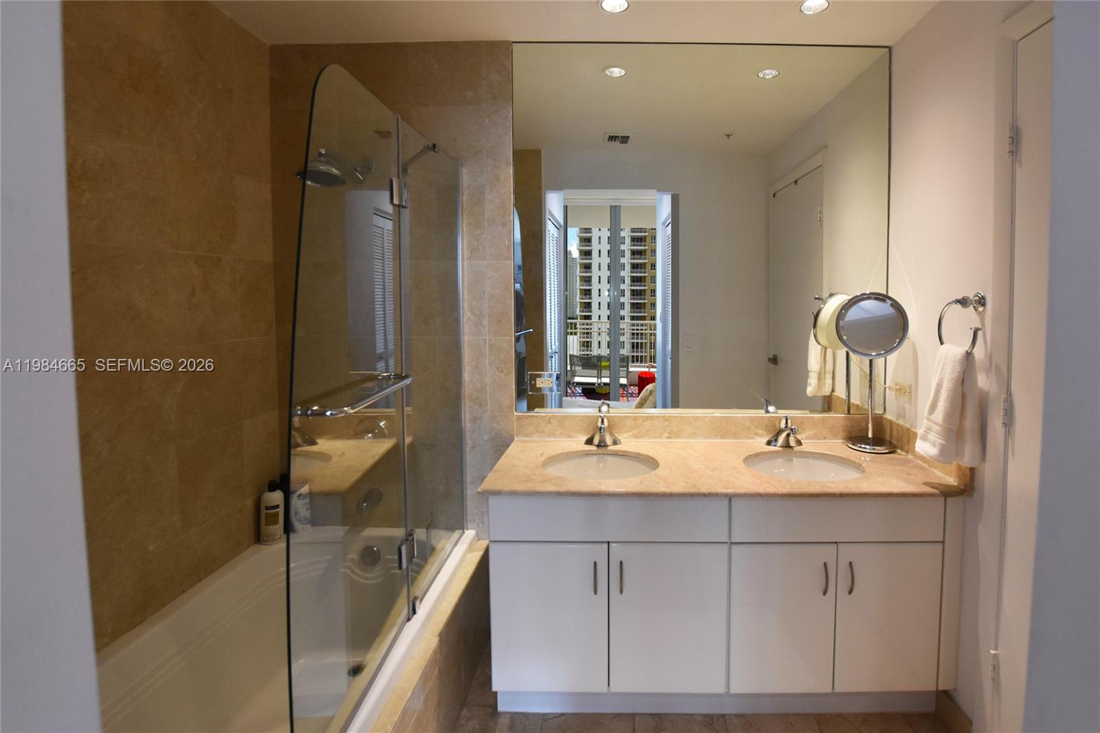 801 Brickell Key Boulevard, Unit 1209 Miami, FL 33131 - Photo 16 of 52 a bathroom with a sink and a mirror