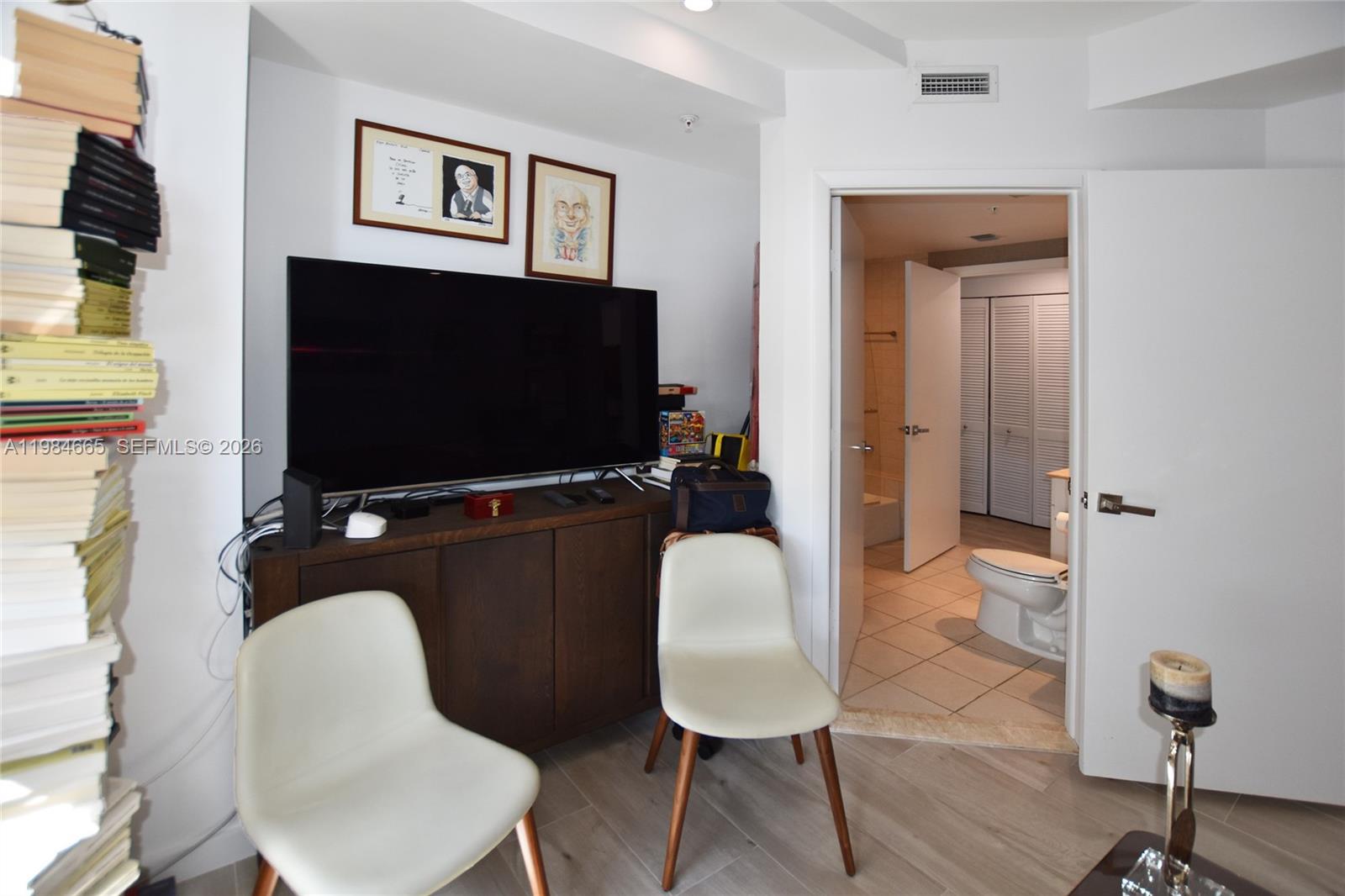 801 Brickell Key Boulevard, Unit 1209 Miami, FL 33131 - Photo 17 of 52 a living room with furniture and a flat screen tv