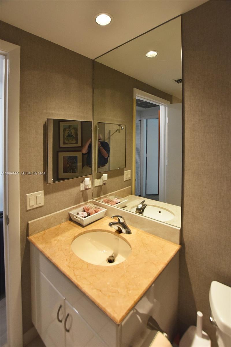 801 Brickell Key Boulevard, Unit 1209 Miami, FL 33131 - Photo 19 of 52 a bathroom with a sink and a mirror