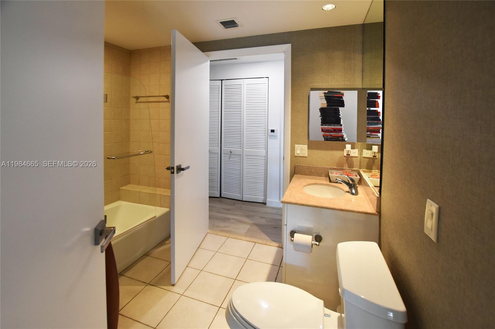 801 Brickell Key Boulevard, Unit 1209 Miami, FL 33131 - Photo 20 of 52 a bathroom with a sink a toilet and shower