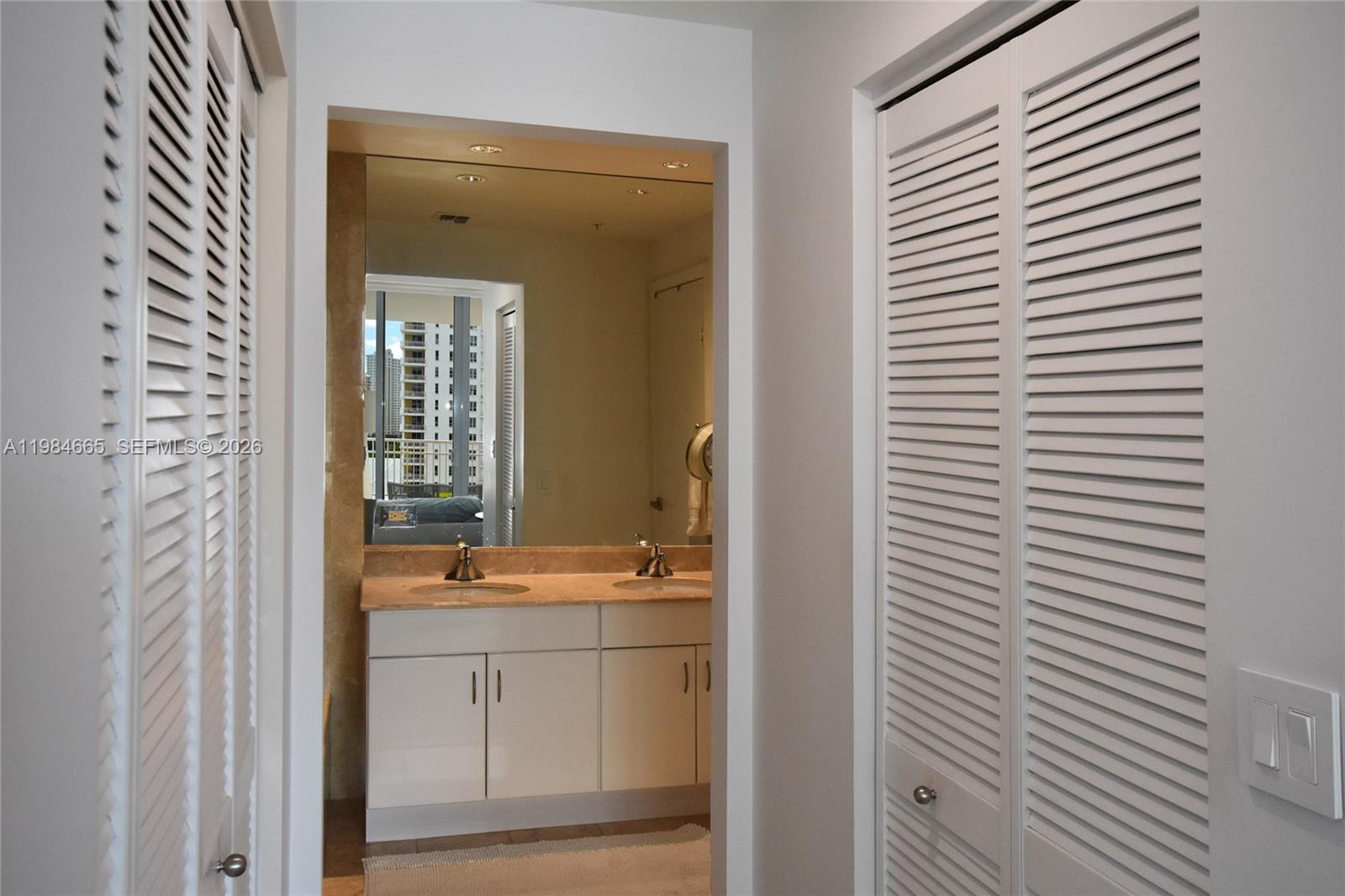 801 Brickell Key Boulevard, Unit 1209 Miami, FL 33131 - Photo 24 of 52 a bathroom with a sink and a mirror
