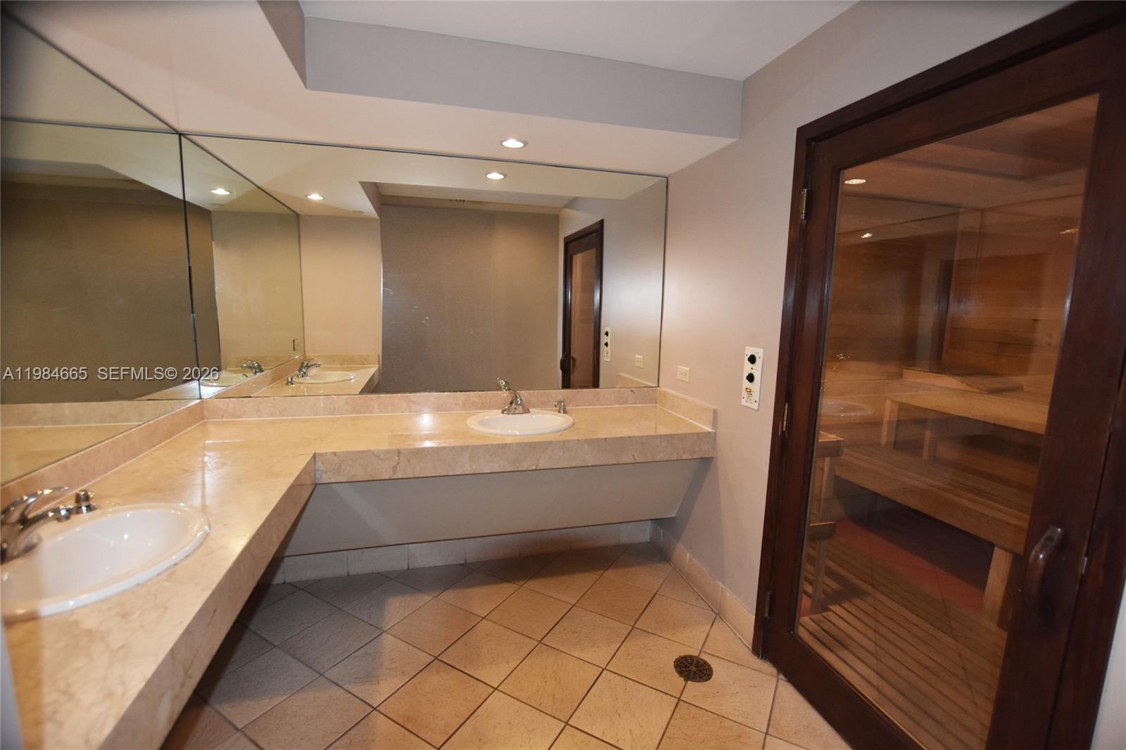 801 Brickell Key Boulevard, Unit 1209 Miami, FL 33131 - Photo 36 of 52 a bathroom with a sink a large mirror and a shower