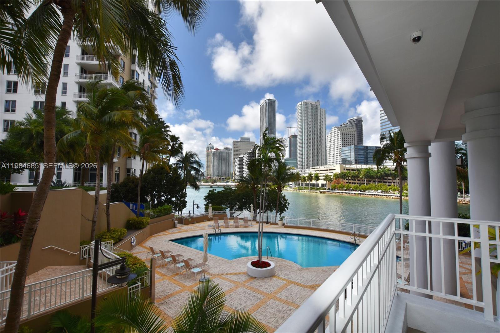 801 Brickell Key Boulevard, Unit 1209 Miami, FL 33131 - Photo 37 of 52 a view of swimming pool and chairs