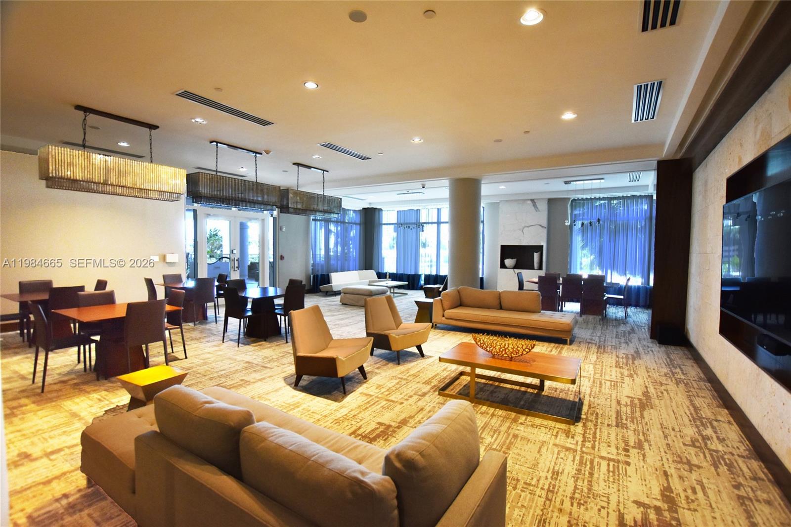 801 Brickell Key Boulevard, Unit 1209 Miami, FL 33131 - Photo 39 of 52 a living room with furniture kitchen view and a table