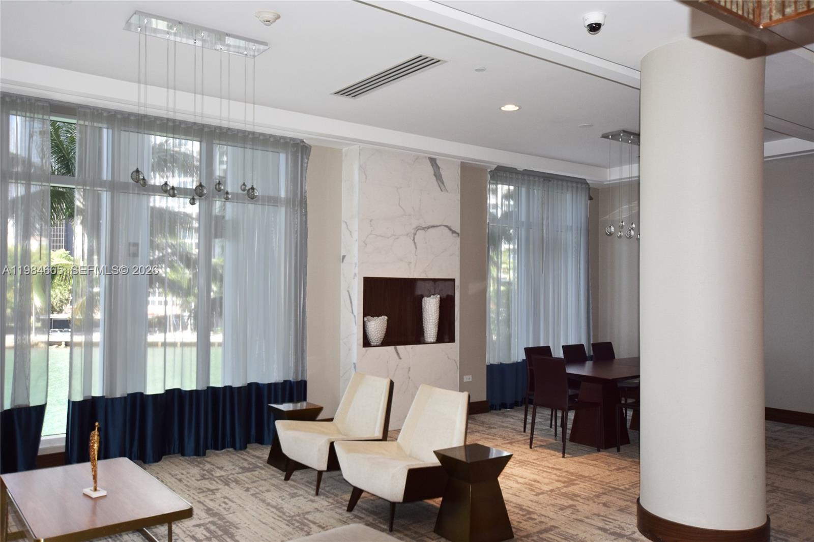 801 Brickell Key Boulevard, Unit 1209 Miami, FL 33131 - Photo 41 of 52 a living room with furniture and a fireplace