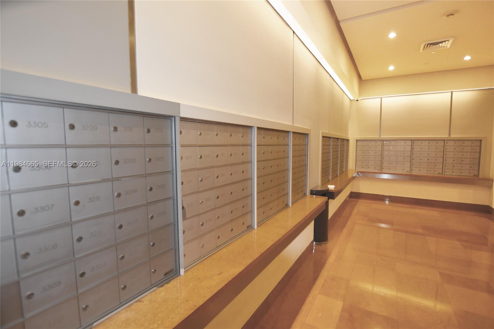 801 Brickell Key Boulevard, Unit 1209 Miami, FL 33131 - Photo 48 of 52 a view of walk in closet with wooden floor