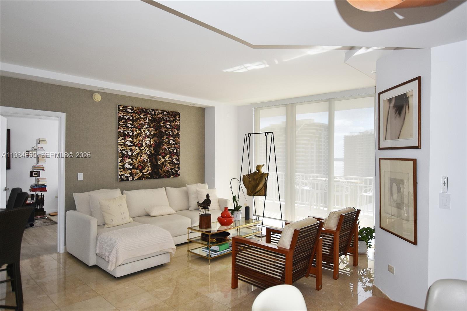 801 Brickell Key Boulevard, Unit 1209 Miami, FL 33131 - Photo 8 of 52 a living room with furniture and a large window
