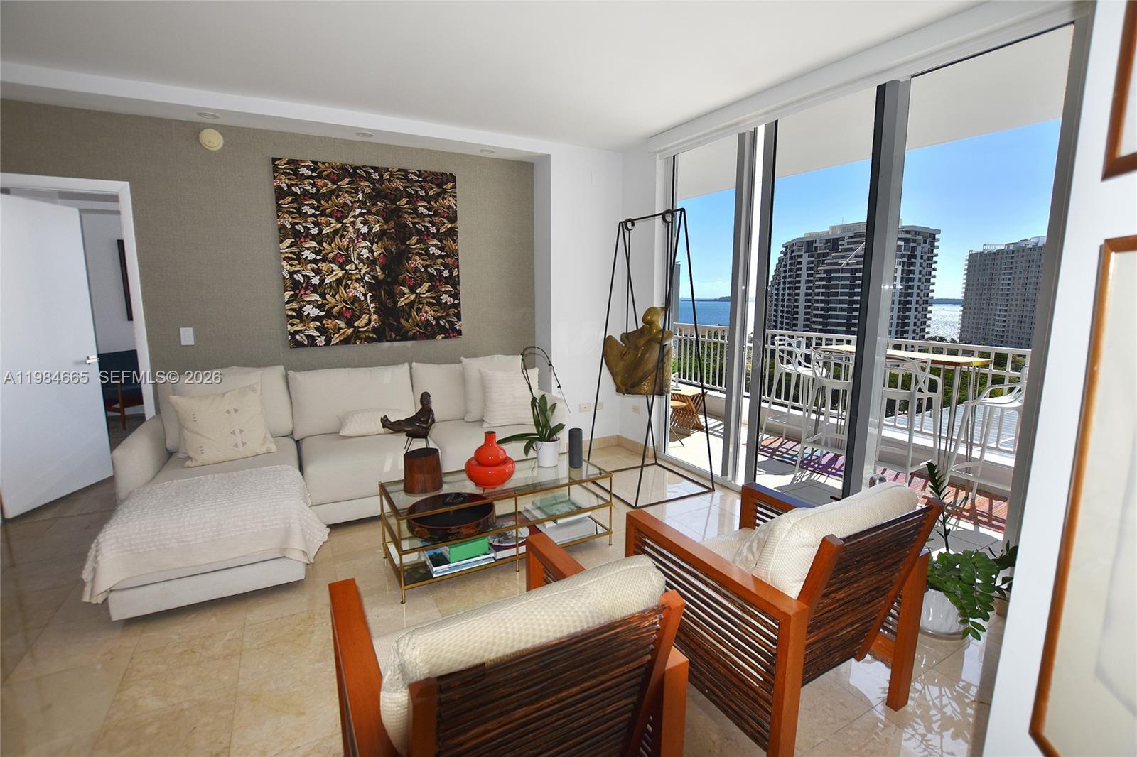 801 Brickell Key Boulevard, Unit 1209 Miami, FL 33131 - Photo 10 of 52 a living room with furniture and a floor to ceiling window