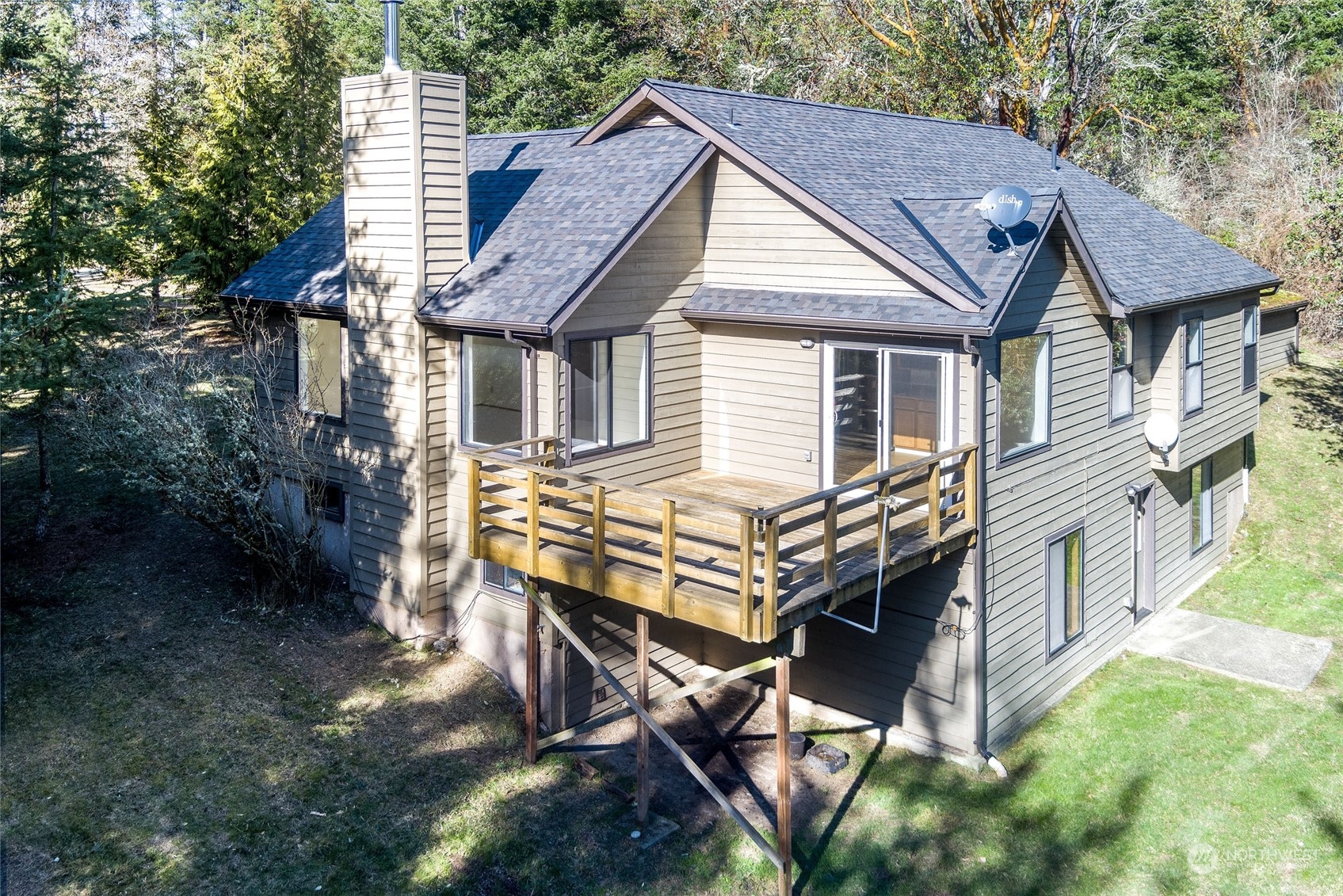 a view of house with backyard and outdoor seating