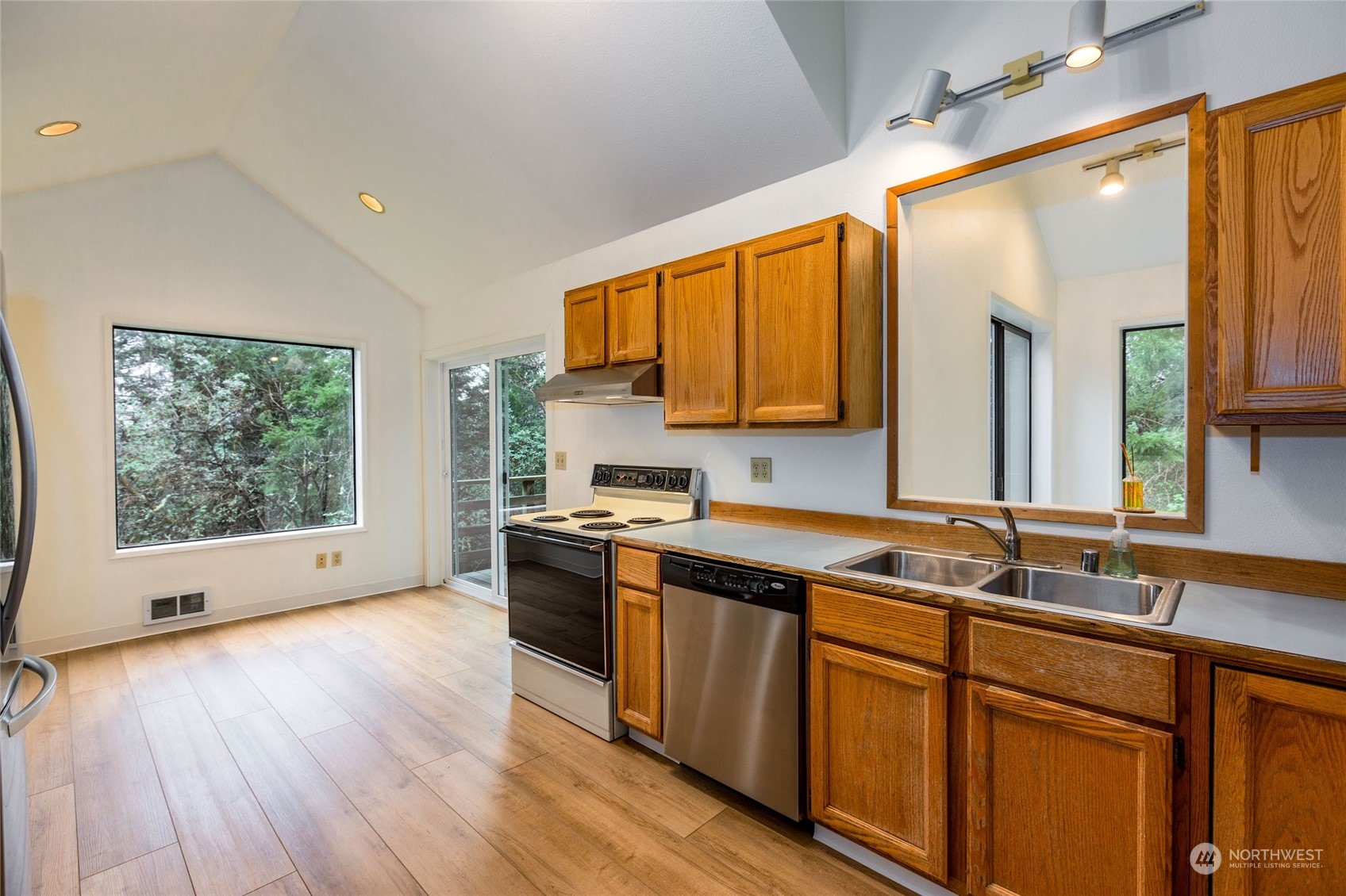 198 Ridgedale Road Friday Harbor, WA 98250 - Photo 2 of 39 a kitchen with stainless steel appliances granite countertop wooden cabinets a sink a stove a window and a microwave