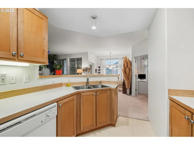 a kitchen with a sink and a wooden floor