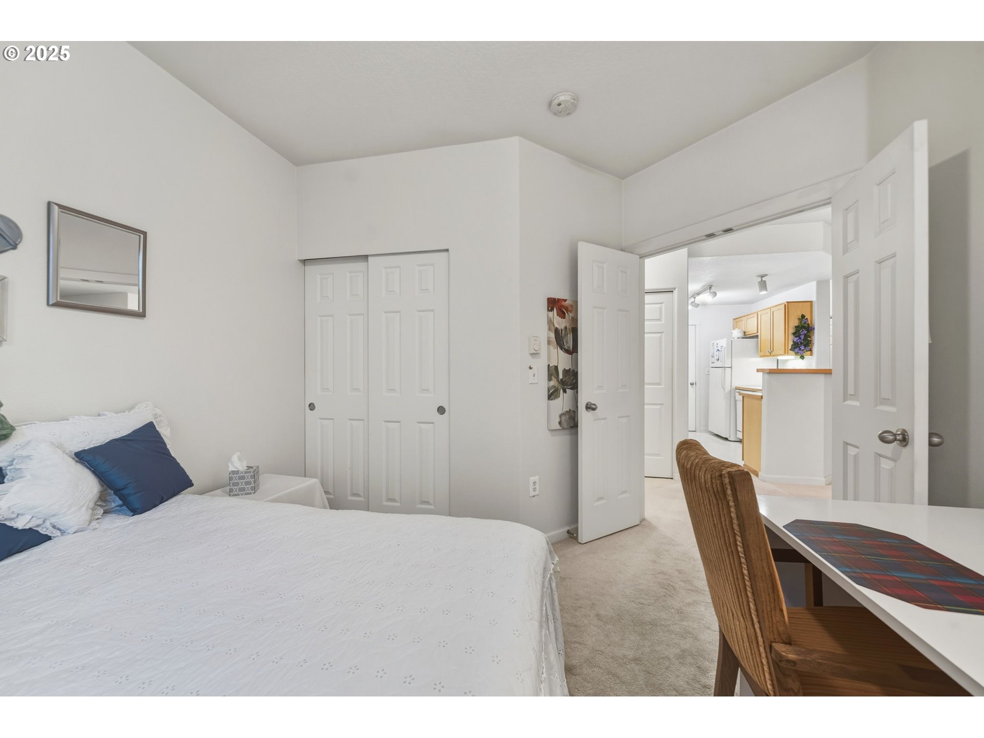 14615 Southwest Beard Road, Unit 101 Beaverton, OR 97007 - Photo 18 of 28 a bedroom with a bed and wooden floor