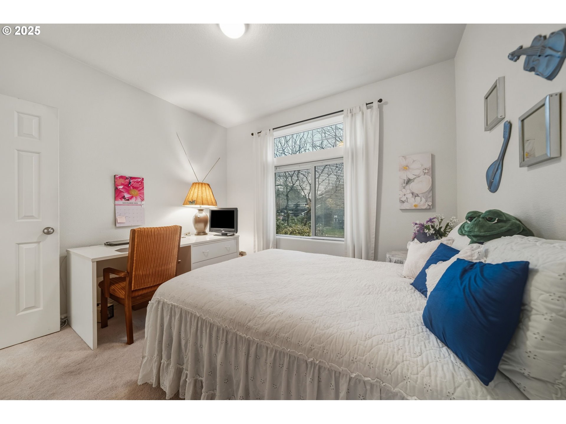 14615 Southwest Beard Road, Unit 101 Beaverton, OR 97007 - Photo 19 of 28 a bedroom with a bed and a dresser with mirror