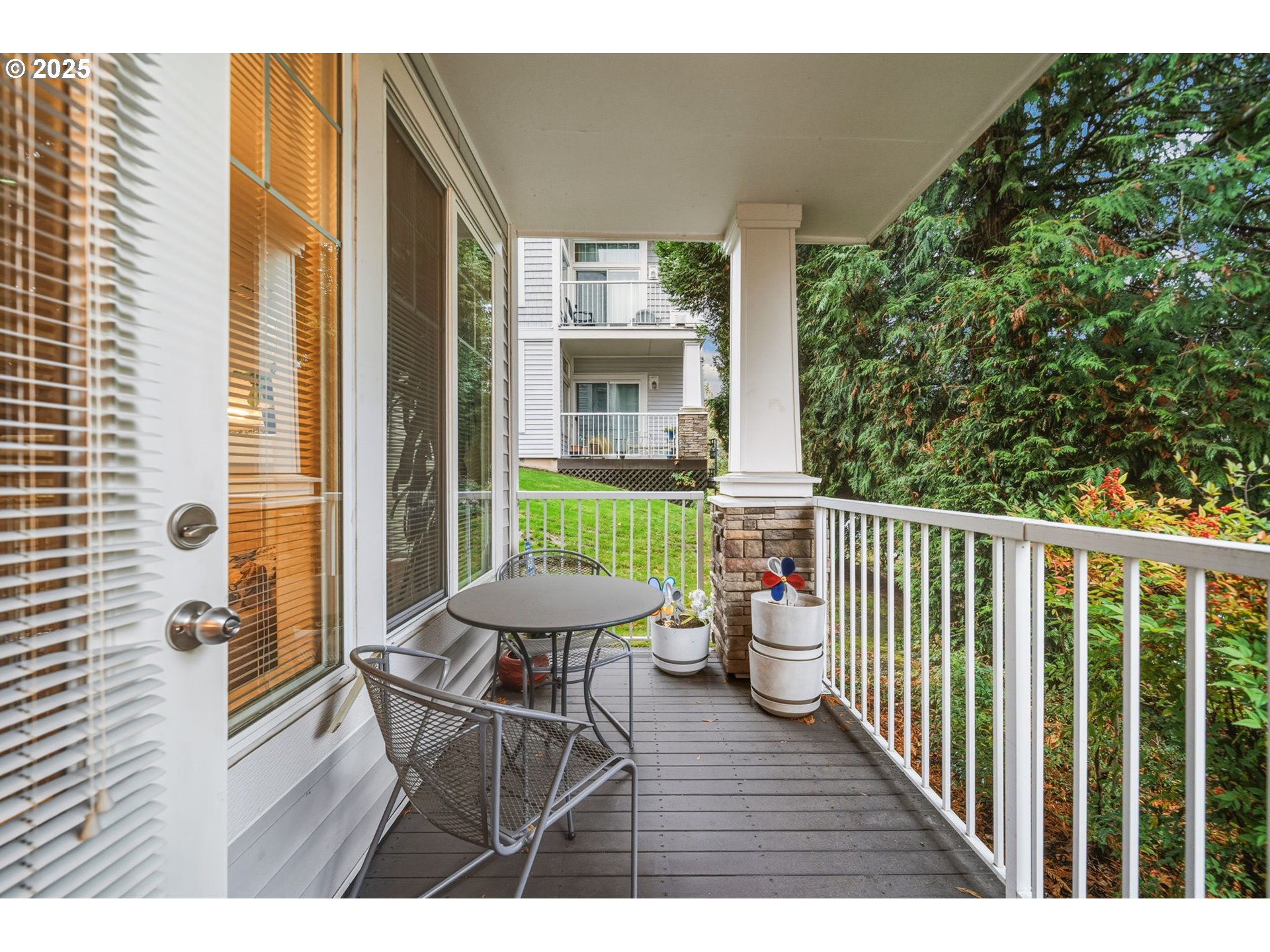 14615 Southwest Beard Road, Unit 101 Beaverton, OR 97007 - Photo 25 of 28 a balcony with wooden floor table and chairs