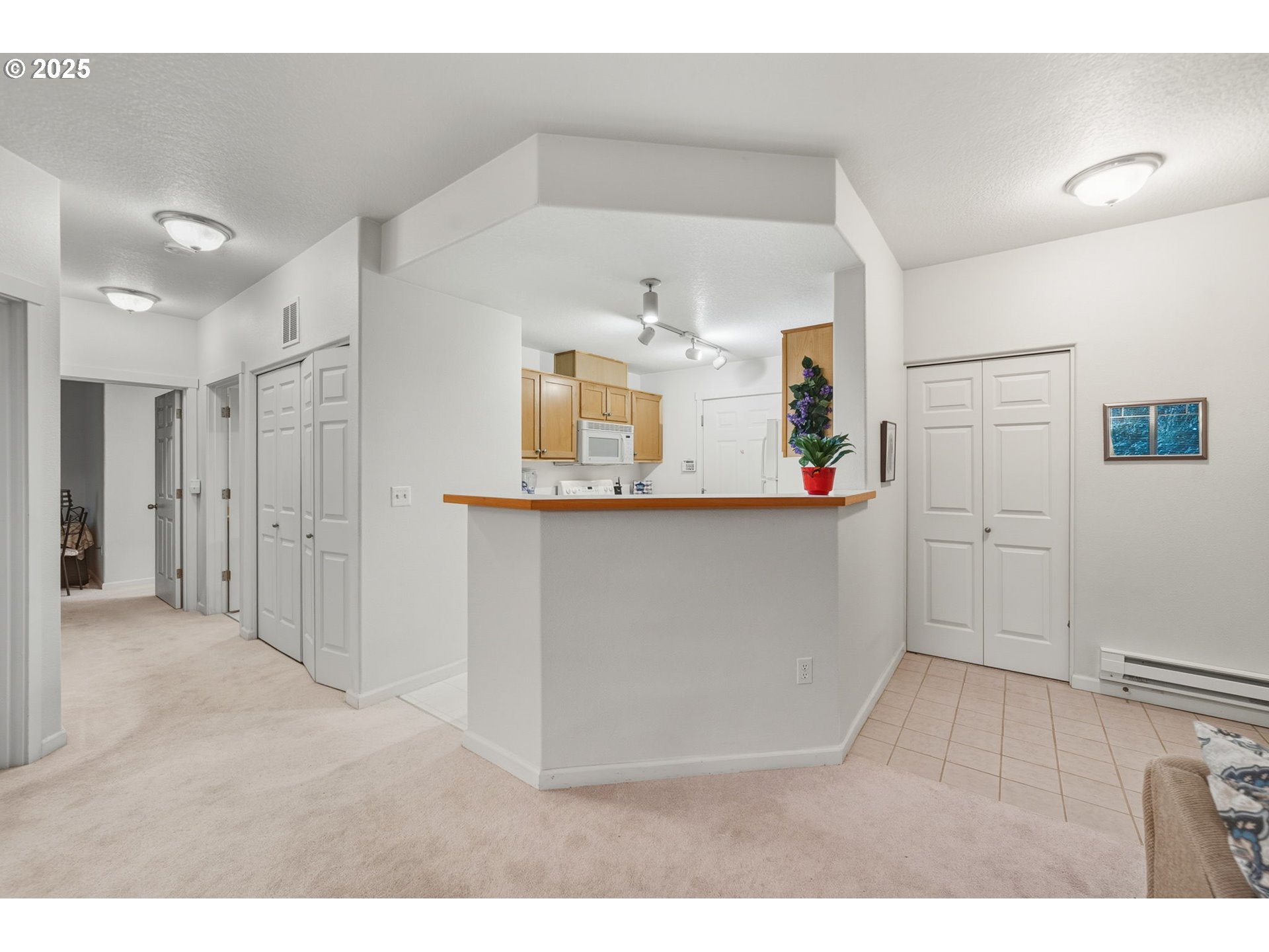 14615 Southwest Beard Road, Unit 101 Beaverton, OR 97007 - Photo 10 of 28 a kitchen with cabinets and wooden floor