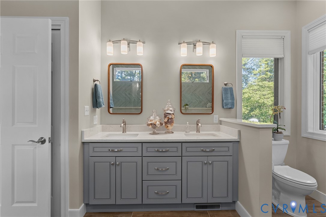 447 Tranquility Road Reedville, VA 22539 - Photo 19 of 82 Double vanity with gray cabinetry, white counterto