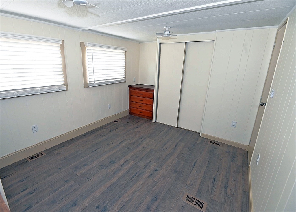 44 Clems Way Acushnet, MA 02743 - Photo 14 of 18 a view of empty room with wooden floor and fan