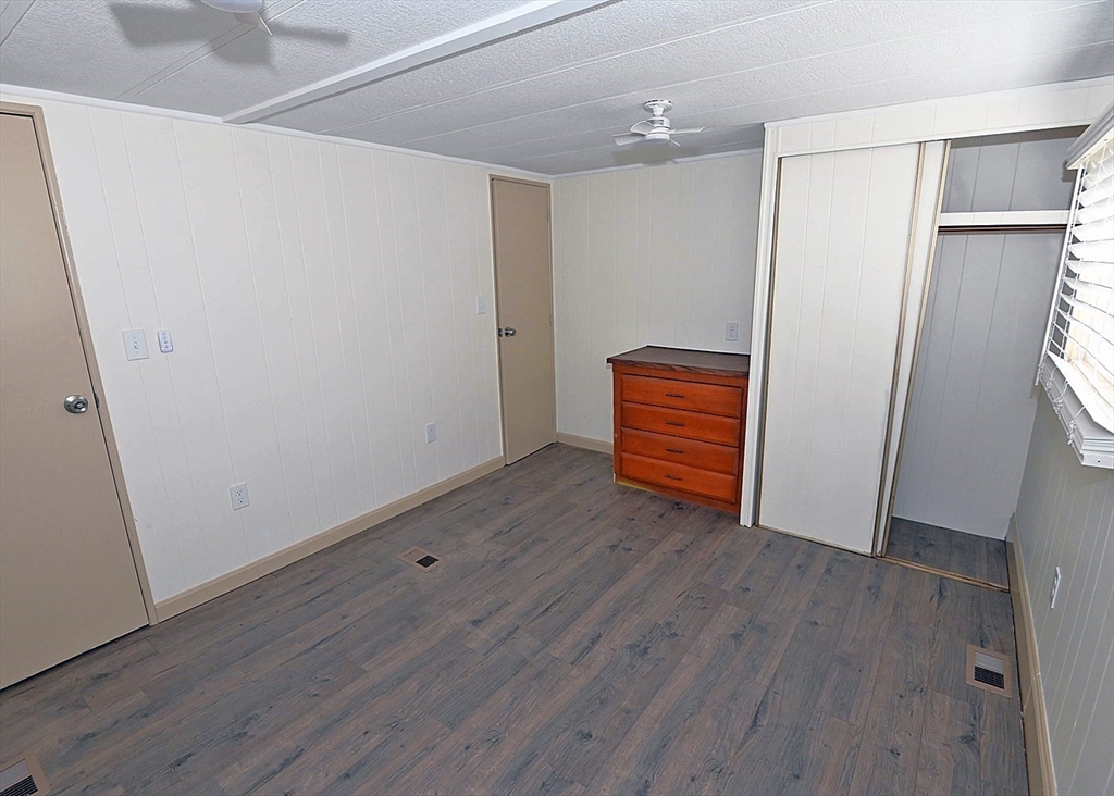 44 Clems Way Acushnet, MA 02743 - Photo 15 of 18 a view of an empty room with wooden floor and a window