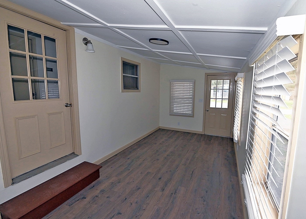 44 Clems Way Acushnet, MA 02743 - Photo 17 of 18 a view of an empty room with wooden floor and windows
