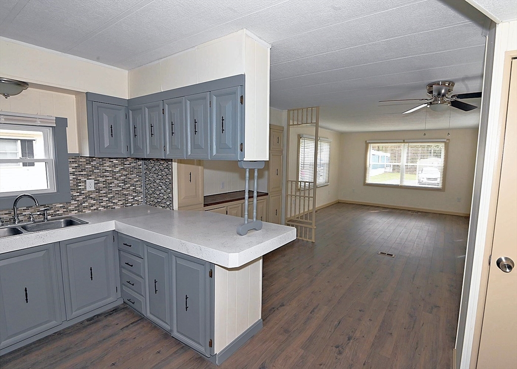 44 Clems Way Acushnet, MA 02743 - Photo 3 of 18 a kitchen with a sink a stove cabinets and wooden floor
