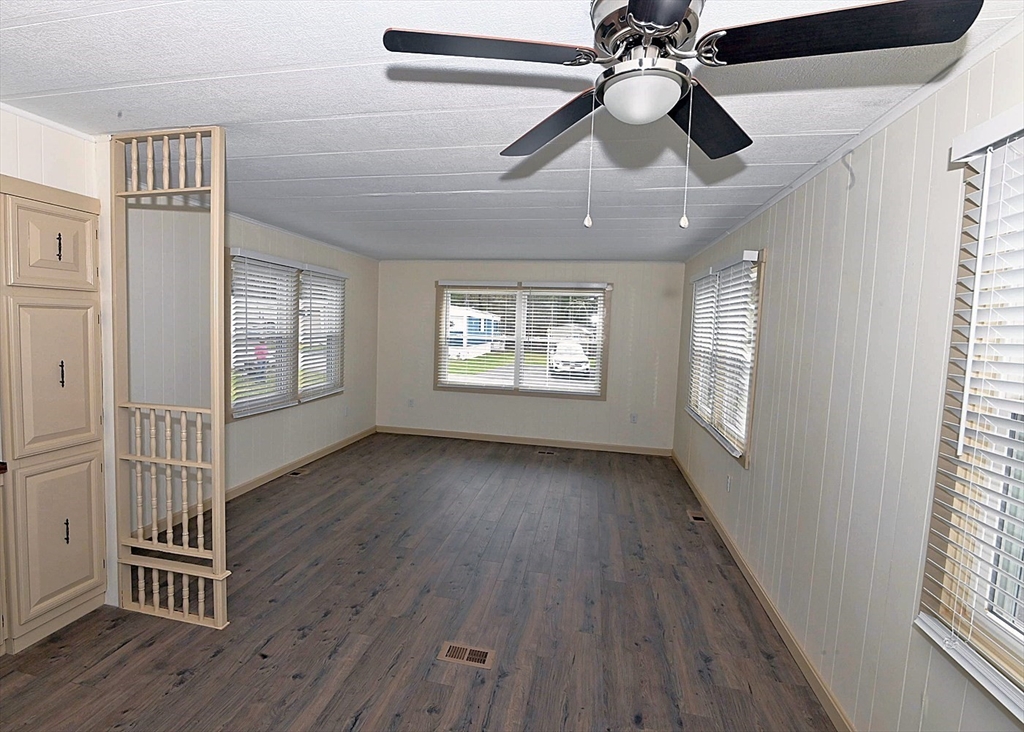 44 Clems Way Acushnet, MA 02743 - Photo 4 of 18 a view of an empty room with wooden floor and a window