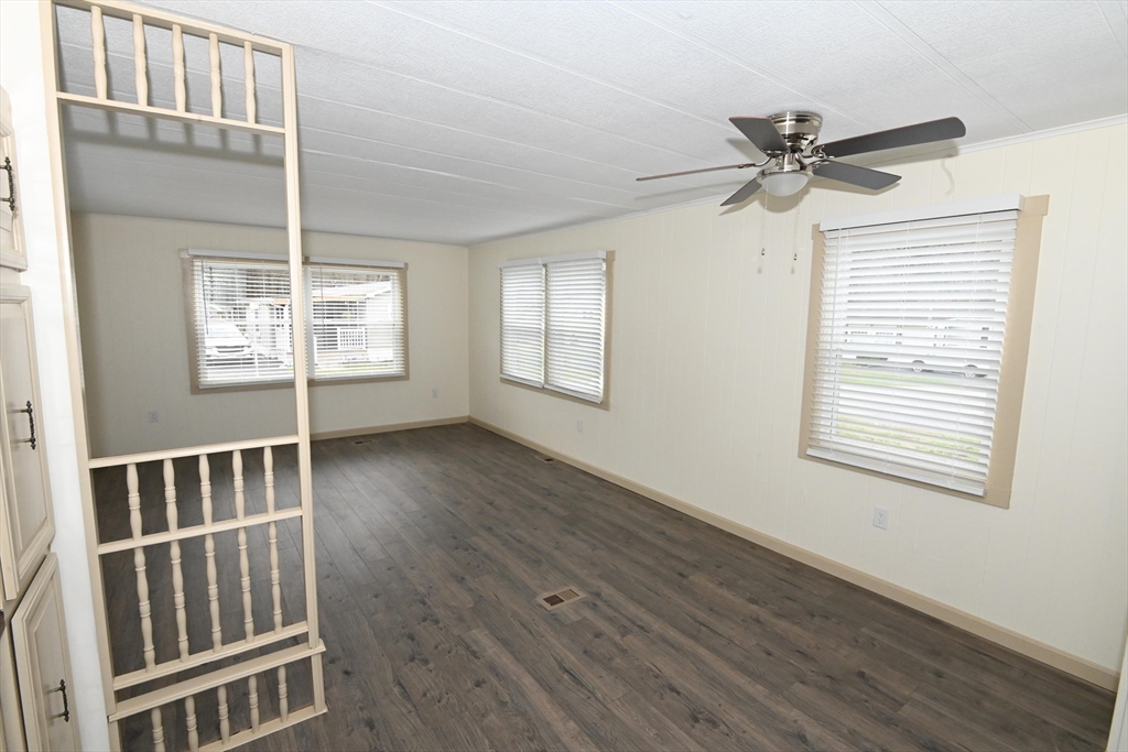 44 Clems Way Acushnet, MA 02743 - Photo 5 of 18 a view of an empty room with wooden floor and a window