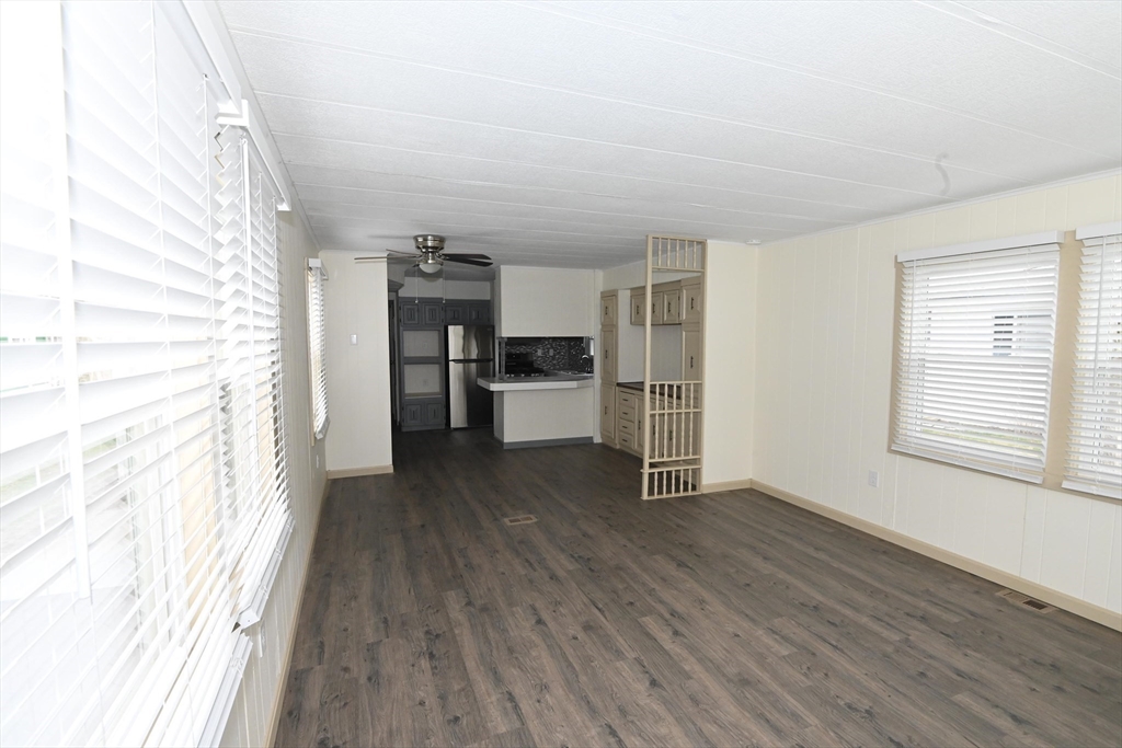 44 Clems Way Acushnet, MA 02743 - Photo 6 of 18 a view of a kitchen with a refrigerator a stove top oven and cabinets