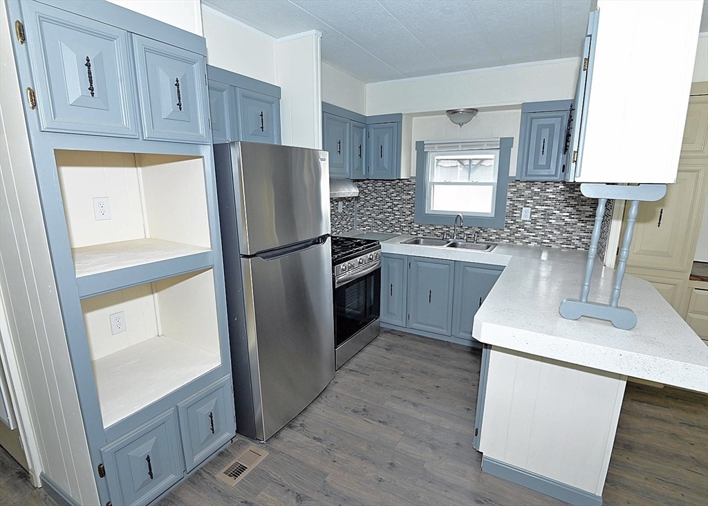 44 Clems Way Acushnet, MA 02743 - Photo 8 of 18 a kitchen with stainless steel appliances granite countertop a refrigerator sink and stove