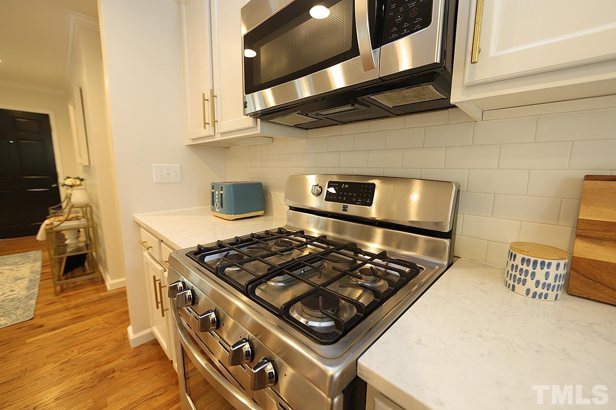 3404 Blue Ridge Road Raleigh, NC 27612 - Photo 10 of 36 a stove top oven sitting inside of a kitchen