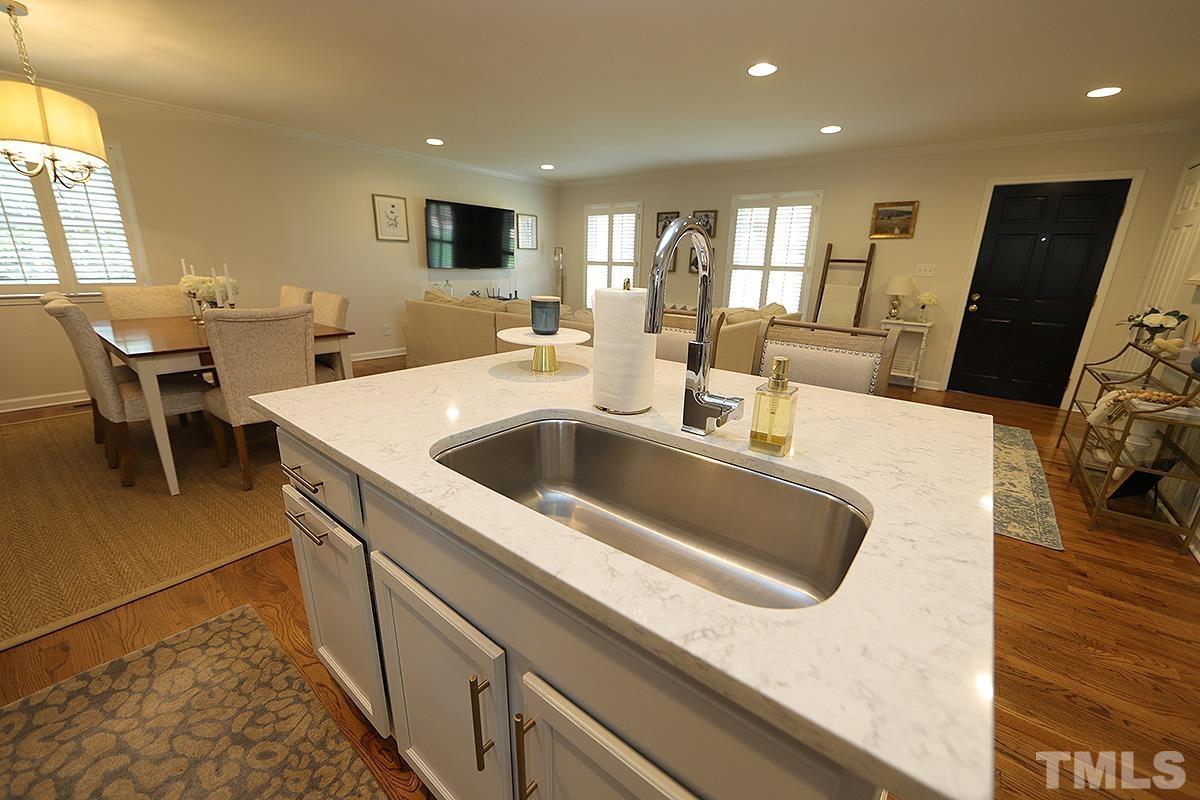 3404 Blue Ridge Road Raleigh, NC 27612 - Photo 12 of 36 a kitchen with a sink and a refrigerator