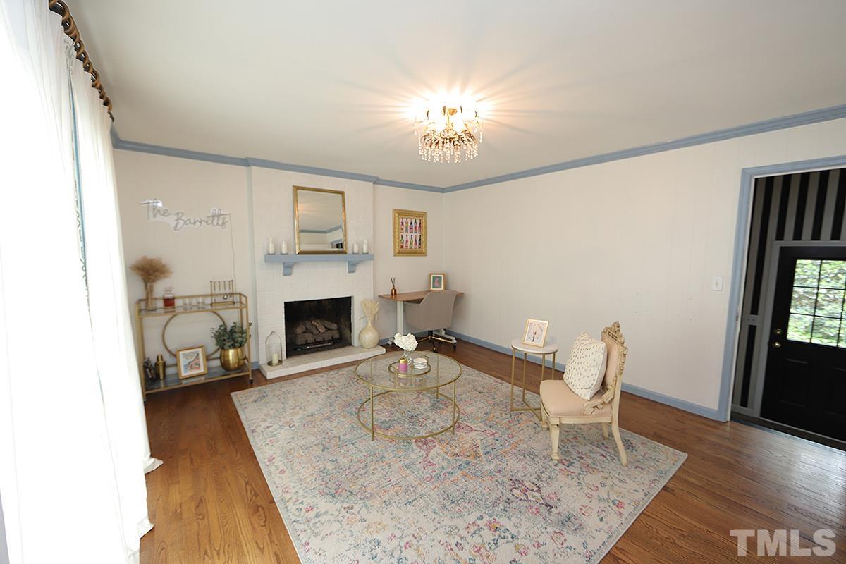 3404 Blue Ridge Road Raleigh, NC 27612 - Photo 16 of 36 a living room with furniture and a fireplace