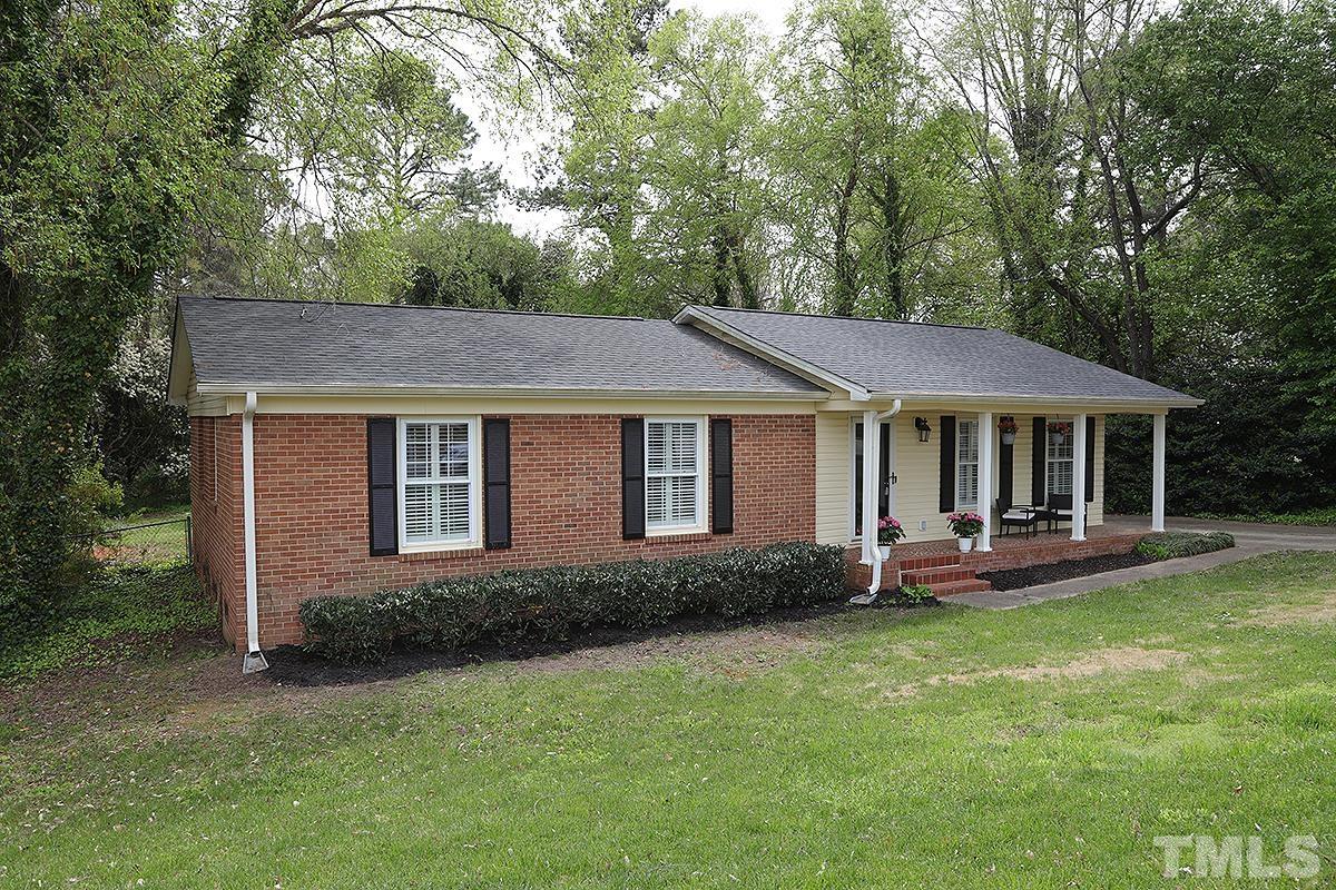 3404 Blue Ridge Road Raleigh, NC 27612 - Photo 2 of 36 a front view of a house with a garden