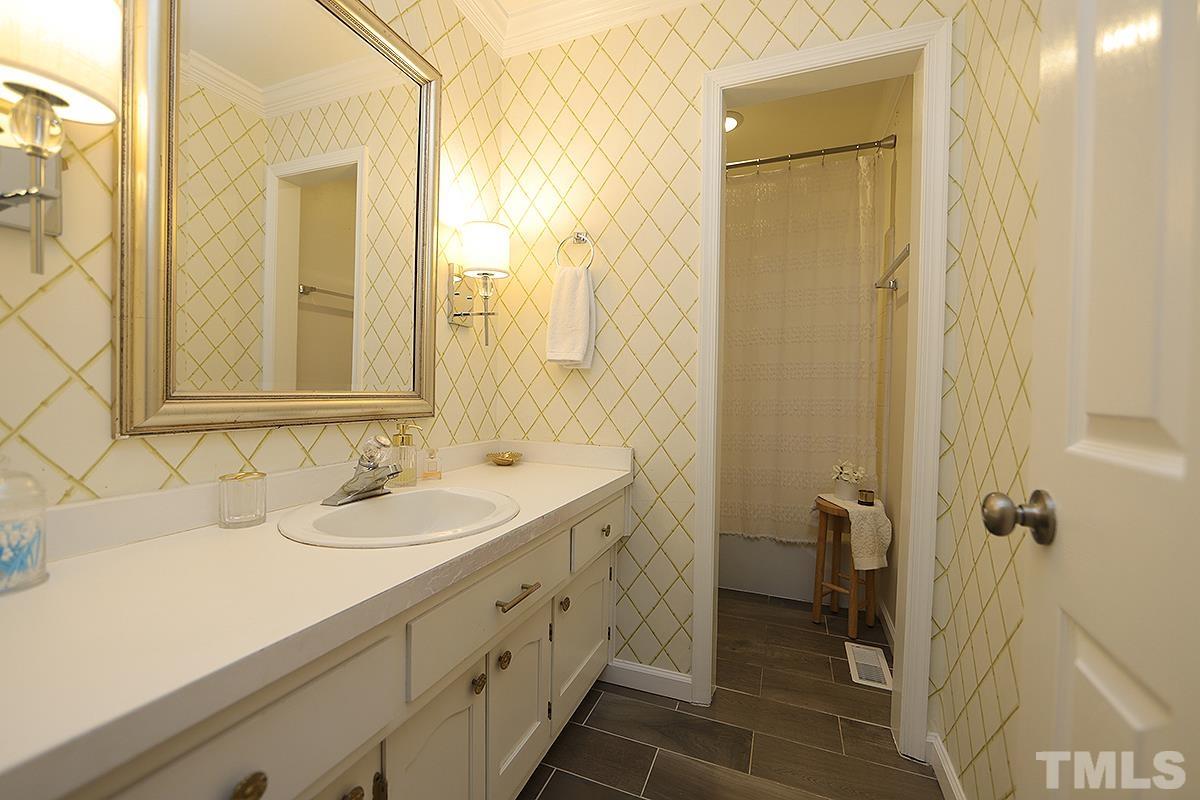 3404 Blue Ridge Road Raleigh, NC 27612 - Photo 20 of 36 a bathroom with a sink and a mirror