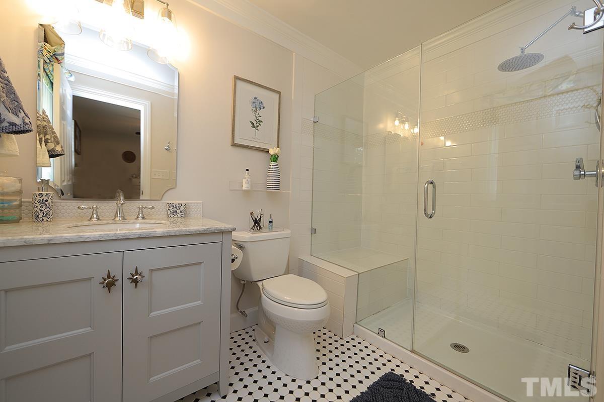3404 Blue Ridge Road Raleigh, NC 27612 - Photo 27 of 36 a bathroom with a sink a toilet and shower