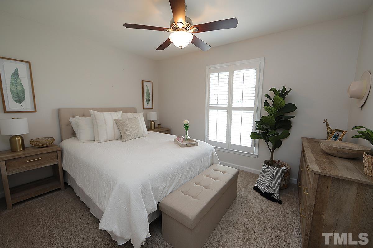 3404 Blue Ridge Road Raleigh, NC 27612 - Photo 29 of 36 a bedroom with a bed and a potted plant