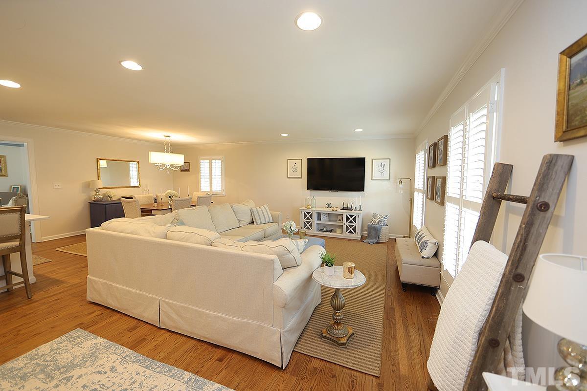 3404 Blue Ridge Road Raleigh, NC 27612 - Photo 6 of 36 a living room with furniture and a flat screen tv