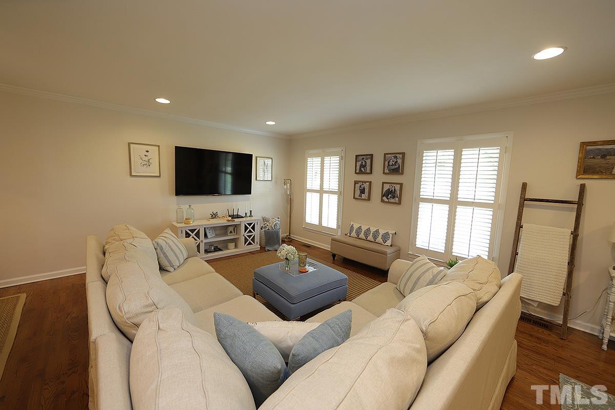 3404 Blue Ridge Road Raleigh, NC 27612 - Photo 8 of 36 a living room with furniture a flat screen tv and a large window