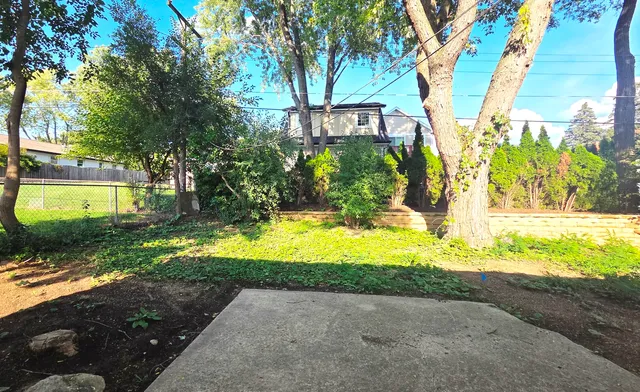 a view of deck with furniture and trees