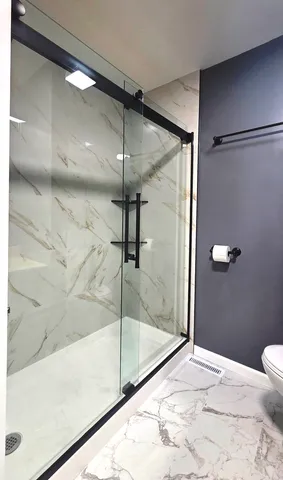 a bathroom with a bathtub and a shower