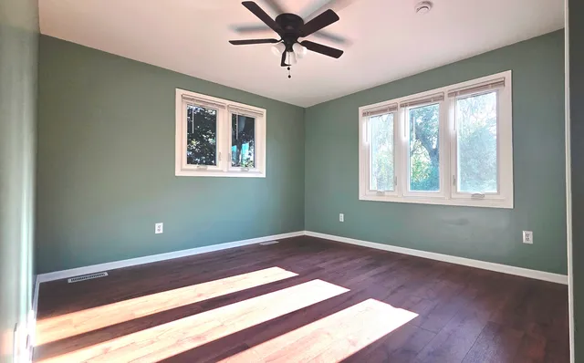 a view of a room with window and ceiling fan
