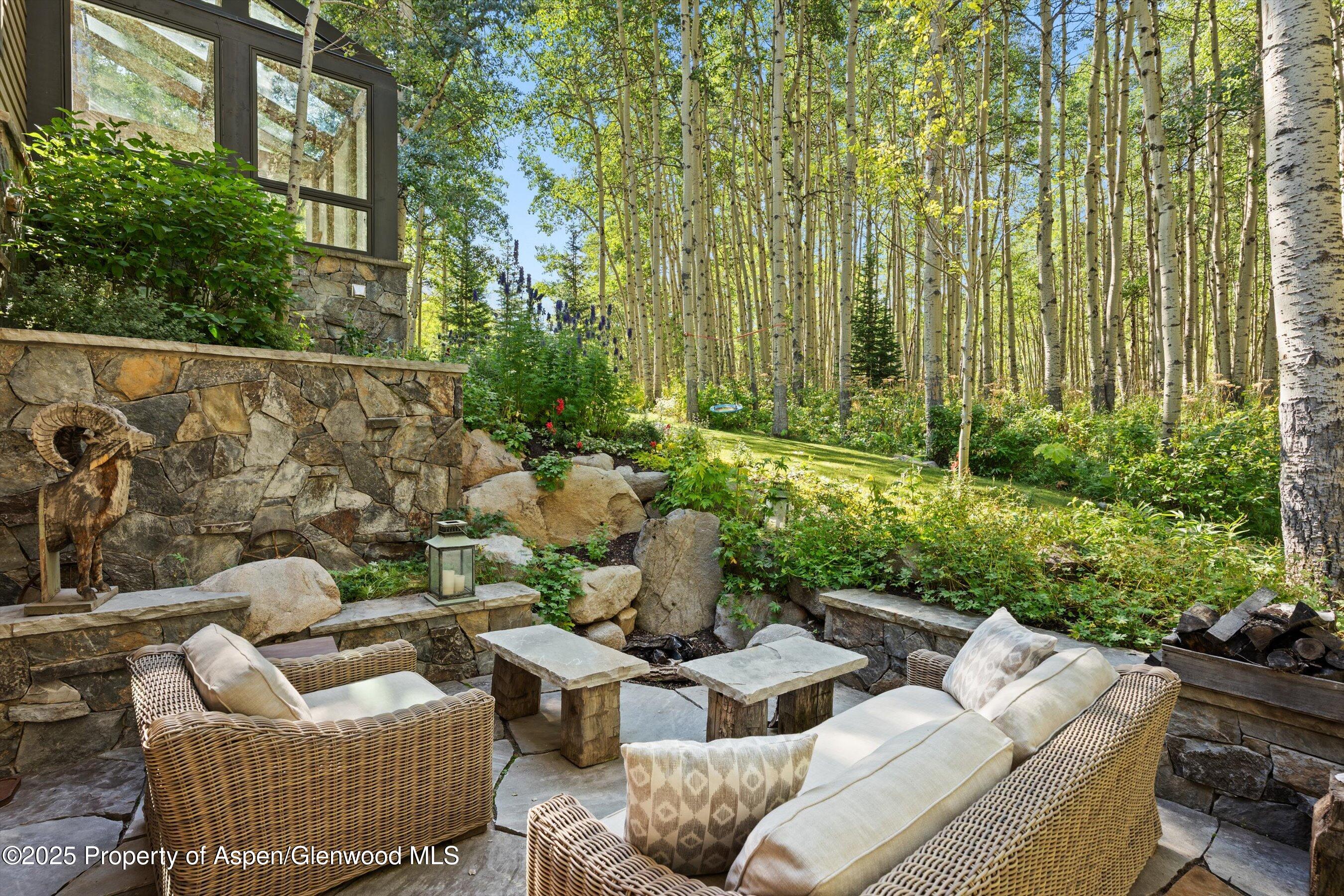 9555 Castle Creek Road Aspen, CO 81612 - Photo 22 of 42 a view of a patio in the backyard