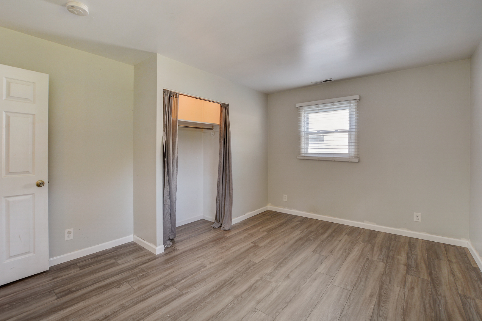 419 South Oltendorf Road Streamwood, IL 60107 - Photo 11 of 24 a view of an empty room with wooden floor and a window