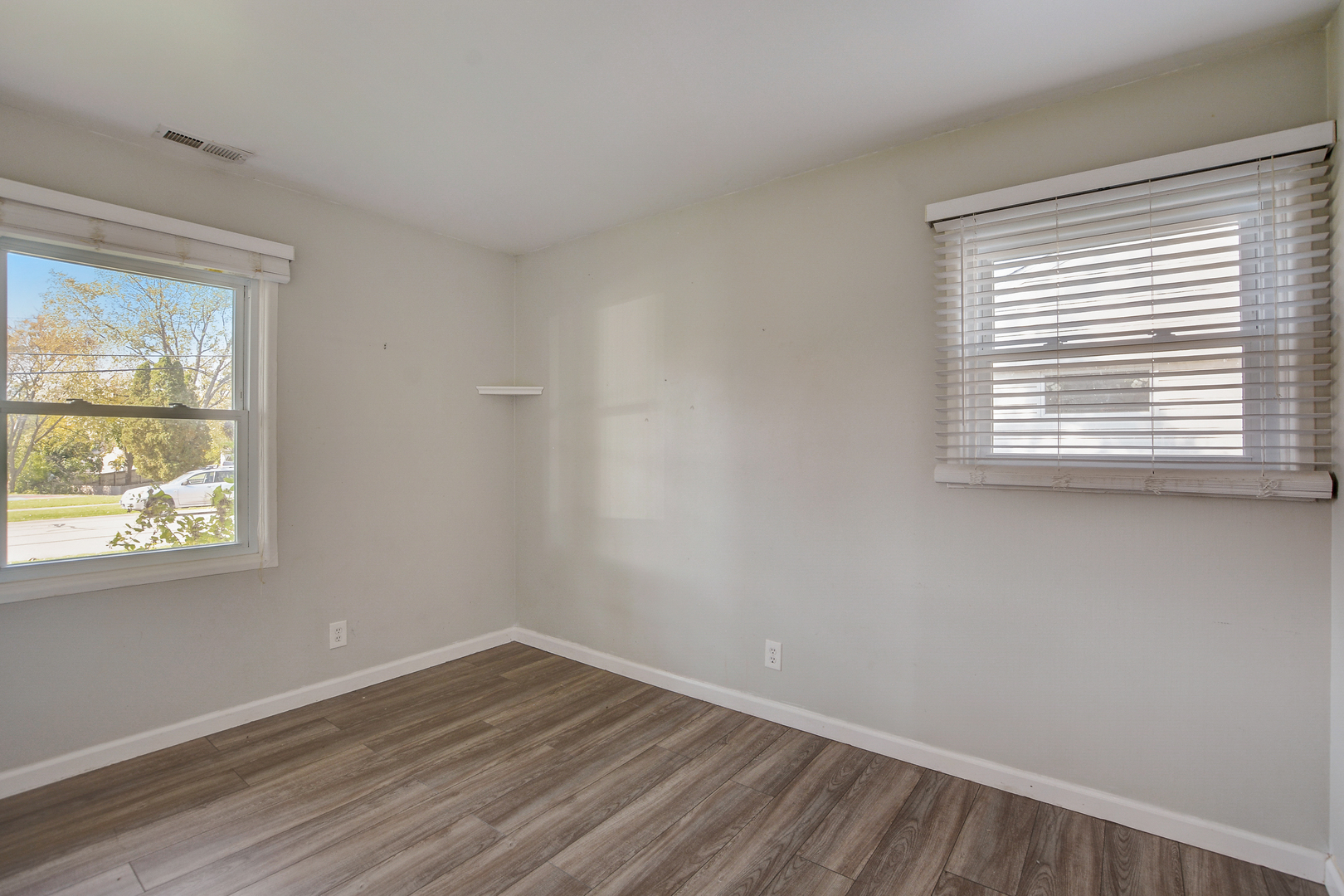 419 South Oltendorf Road Streamwood, IL 60107 - Photo 12 of 24 a view of an empty room with wooden floor and a window