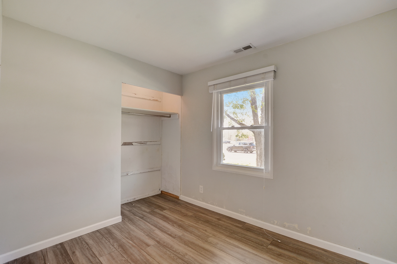 419 South Oltendorf Road Streamwood, IL 60107 - Photo 14 of 24 an empty room with wooden floor and windows