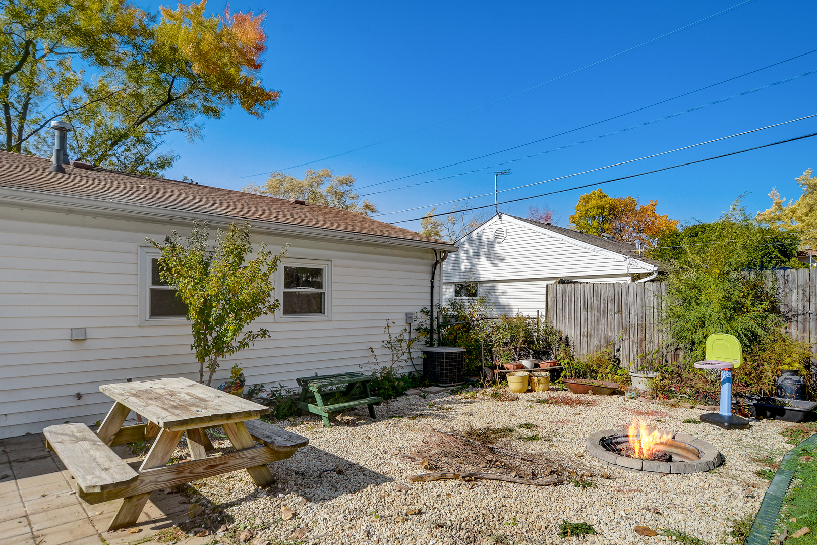 419 South Oltendorf Road Streamwood, IL 60107 - Photo 18 of 24 a view of a backyard with table and chairs under an umbrella