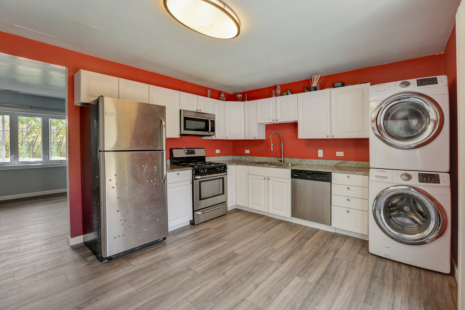 419 South Oltendorf Road Streamwood, IL 60107 - Photo 5 of 24 a kitchen with stainless steel appliances granite countertop a refrigerator a stove and a wooden floors