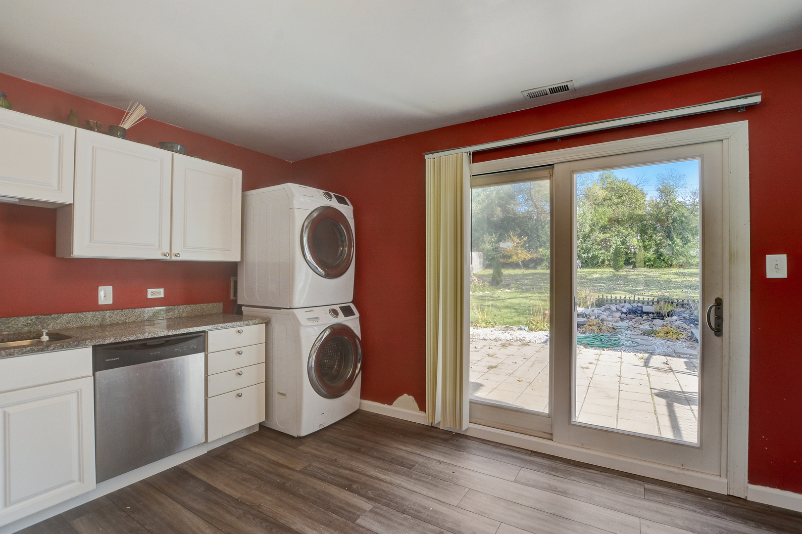 419 South Oltendorf Road Streamwood, IL 60107 - Photo 7 of 24 a kitchen with a refrigerator a stove top oven and wooden floors